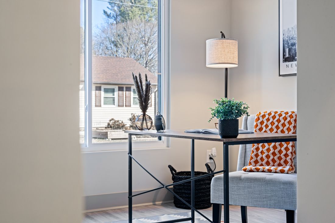A calm, plant-filled home office desk by a window — the kind of space a telehealth practice can run from