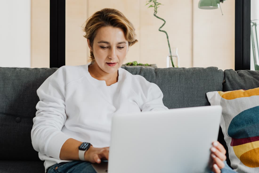 A client comfortably searching for a counsellor from home on a laptop