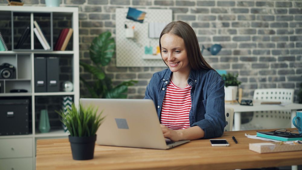 A practitioner working on her own practice from a laptop